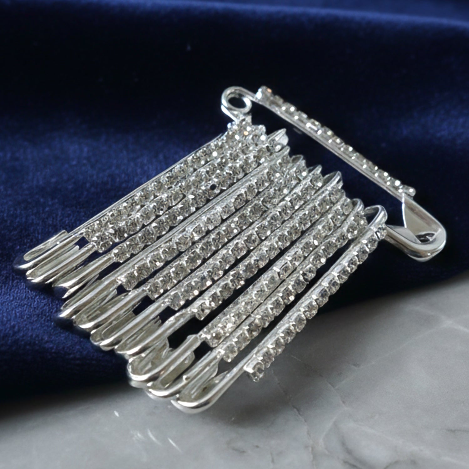 Set of 12 decorative silver finish safety pin brooches by Wukusy, featuring stylish and versatile accessory designs.