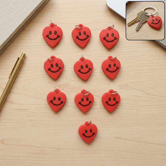 Set of 10 Wukusy cute smiley heart-shaped bag charm keychains featuring colorful designs and playful smiley faces.