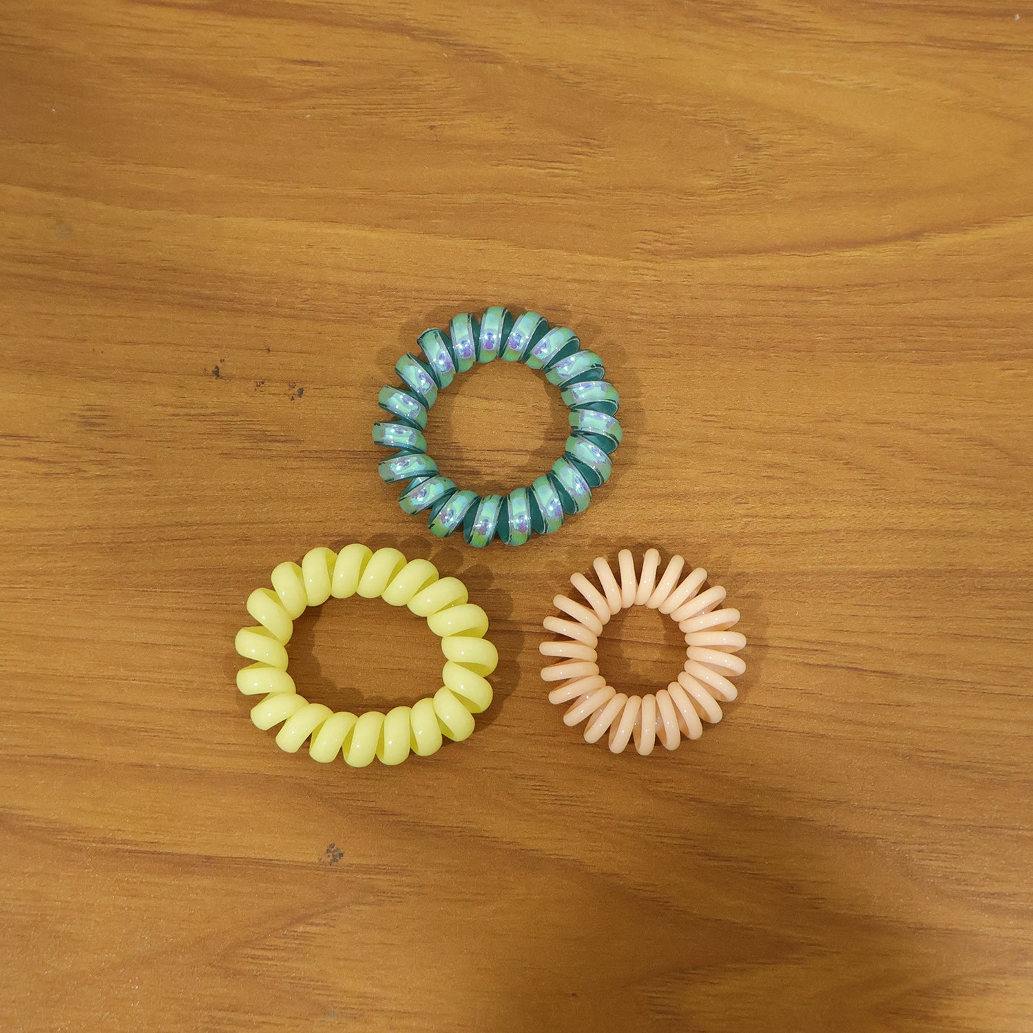 Colorful telephone wire hair band by Wukusy, featuring a mix of vibrant colors and flexible design for hair styling.