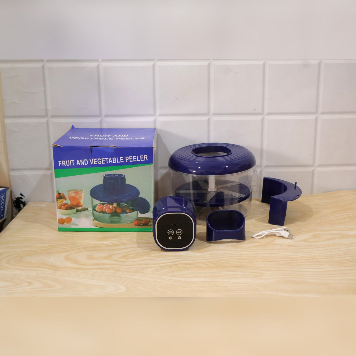 Wukusy electric food chopper with steel blades and clear bowl, showing the compact design and stainless steel blades for chopping.
