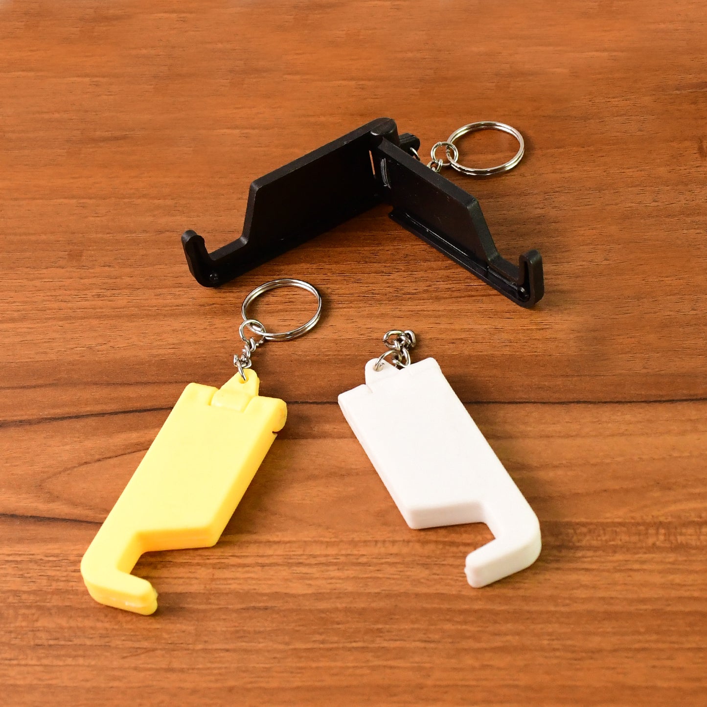 Set of 5 multicolor 2-in-1 plastic keychains with mobile stands and phone holders by Wukusy, ideal for office use.