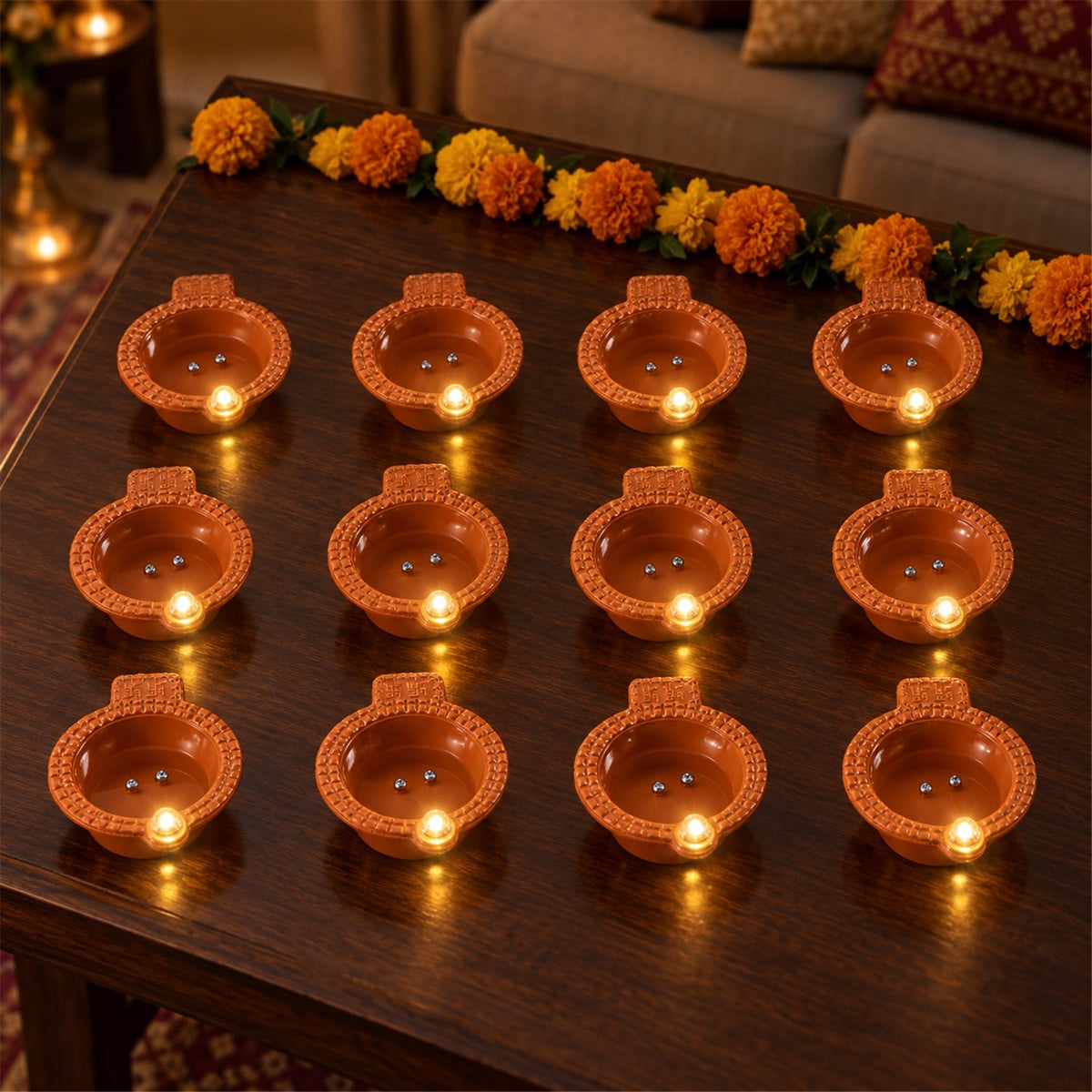 Set of 12 Wukusy flameless LED diyas with water sensor for Diwali and pooja decoration, featuring realistic diya designs and warm light.