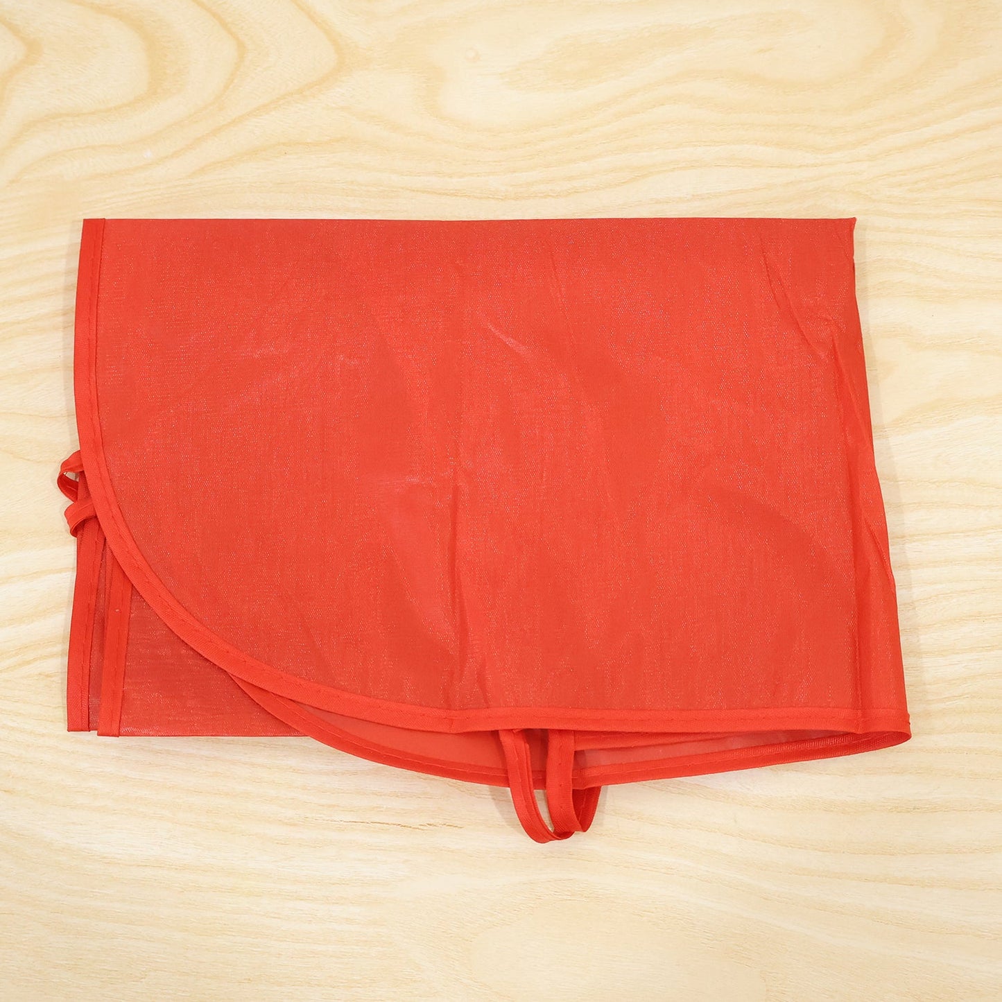 Wukusy reusable cooking apron with front pocket and adjustable neck strap, shown hanging in a kitchen setting