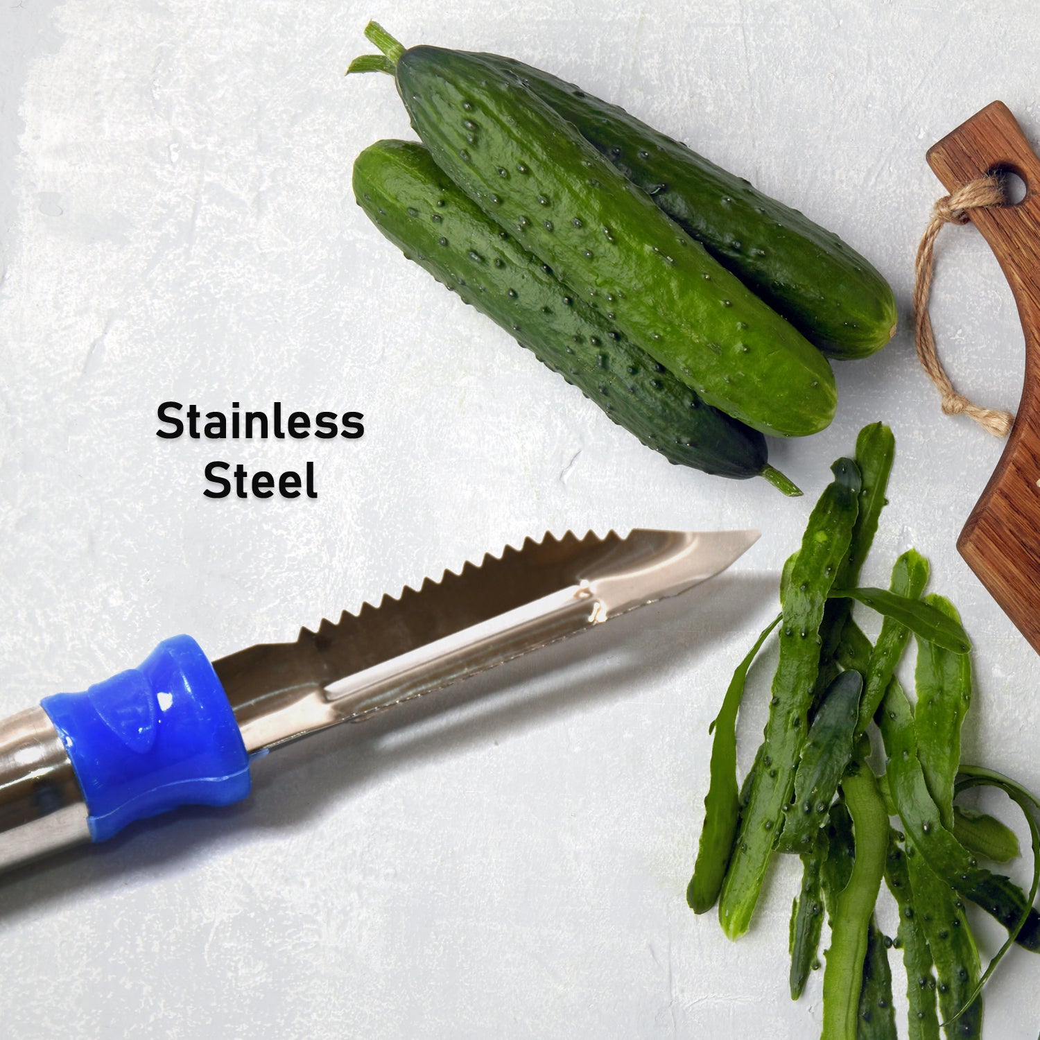 Wukusy 2-in-1 stainless steel vegetable peeler with hanging ring for peeling and shredding carrots, potatoes, and fruit in kitchen.