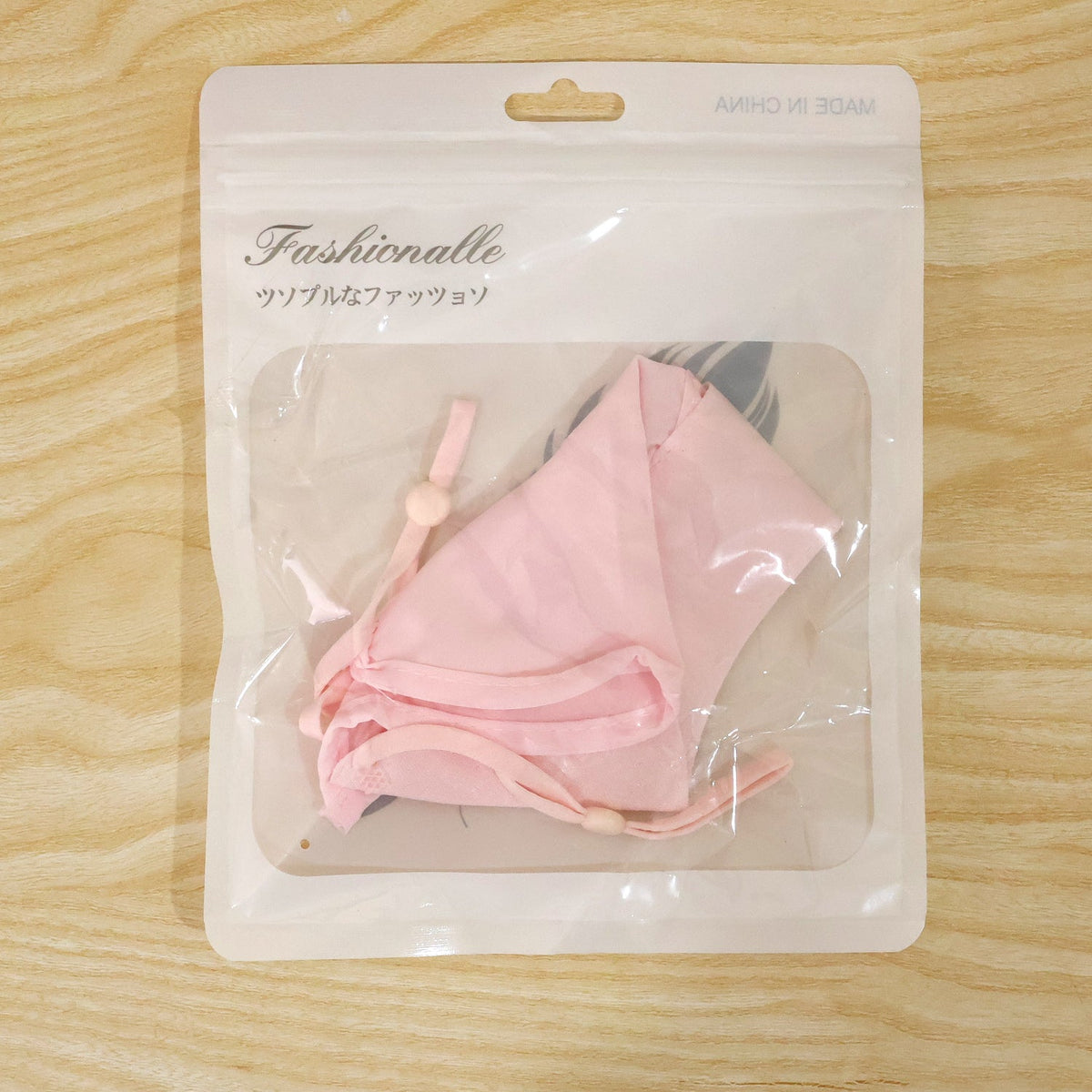 Wukusy reusable fabric face mask with adjustable ear loops, designed for daily wear, shown in a close-up image.