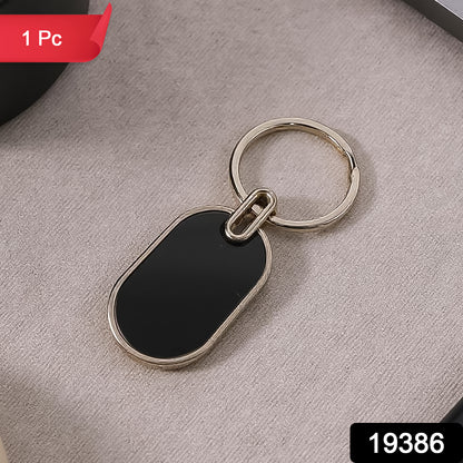 Elegant black and silver oval metal keychain by Wukusy, featuring a sleek design and sturdy metal construction.