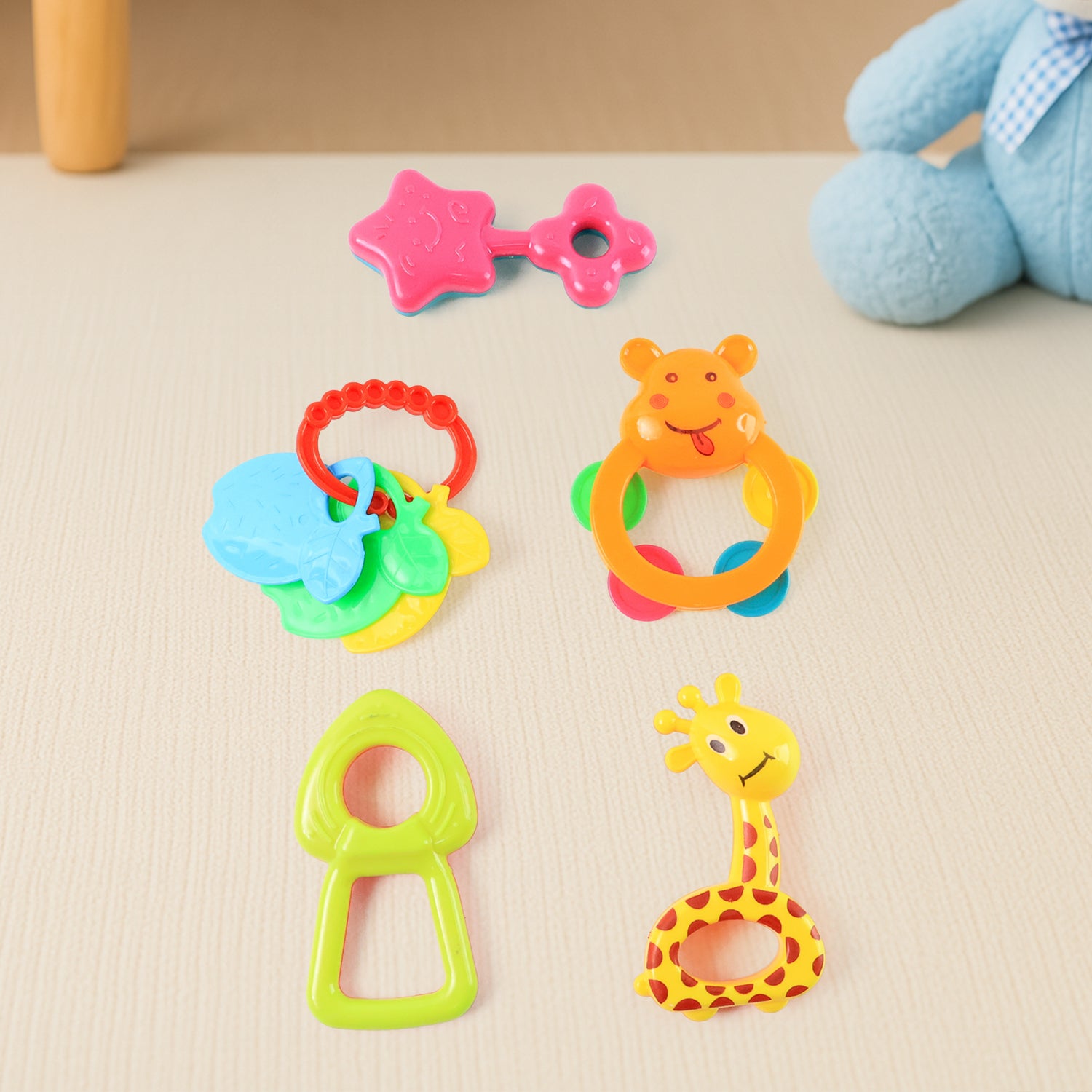 Set of five Wukusy plastic baby rattle toys with colorful handles and textured surfaces, designed for infant entertainment and sensory development.