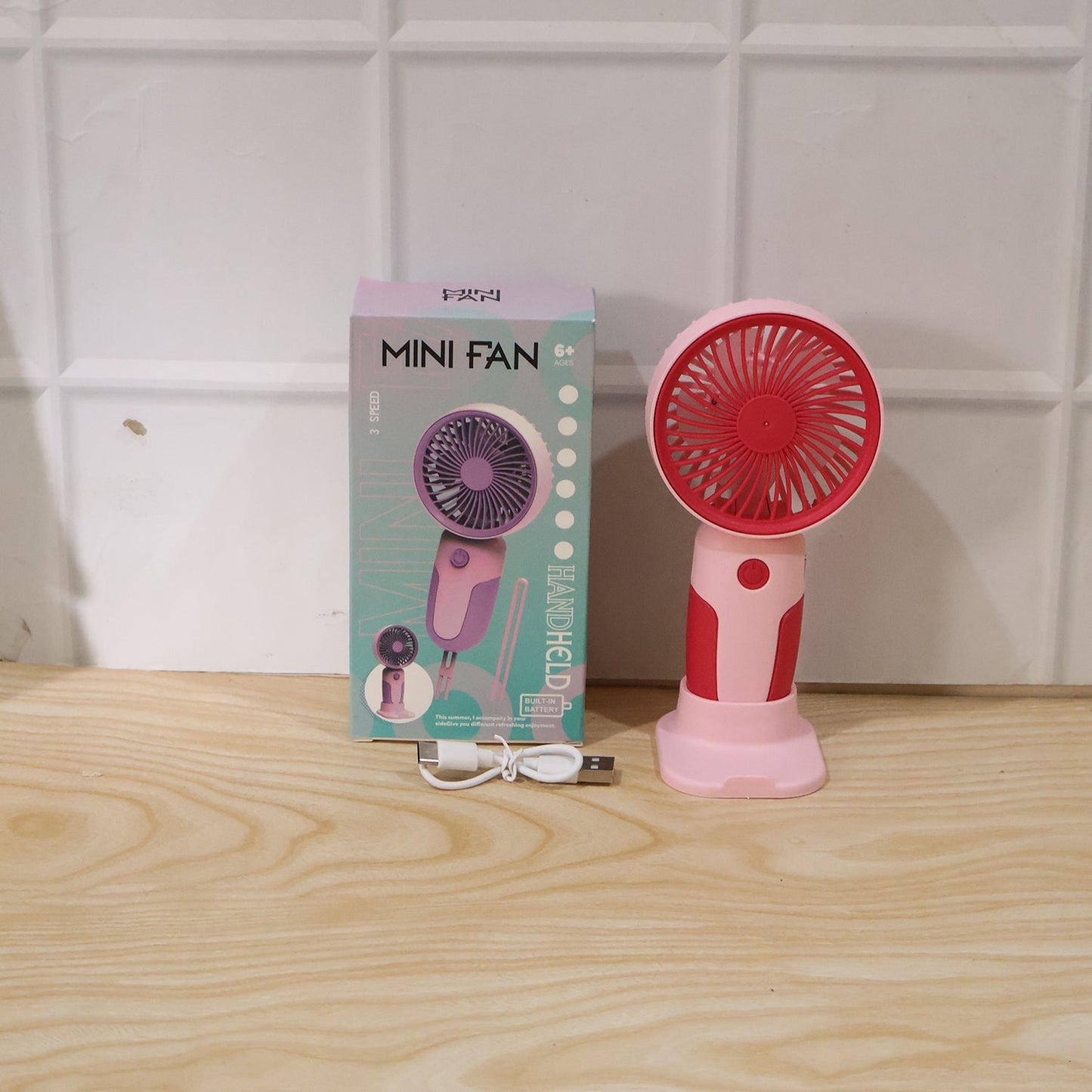 Wukusy mini handheld rechargeable personal fan with stand, portable USB desk fan, black compact design, ideal for personal cooling.