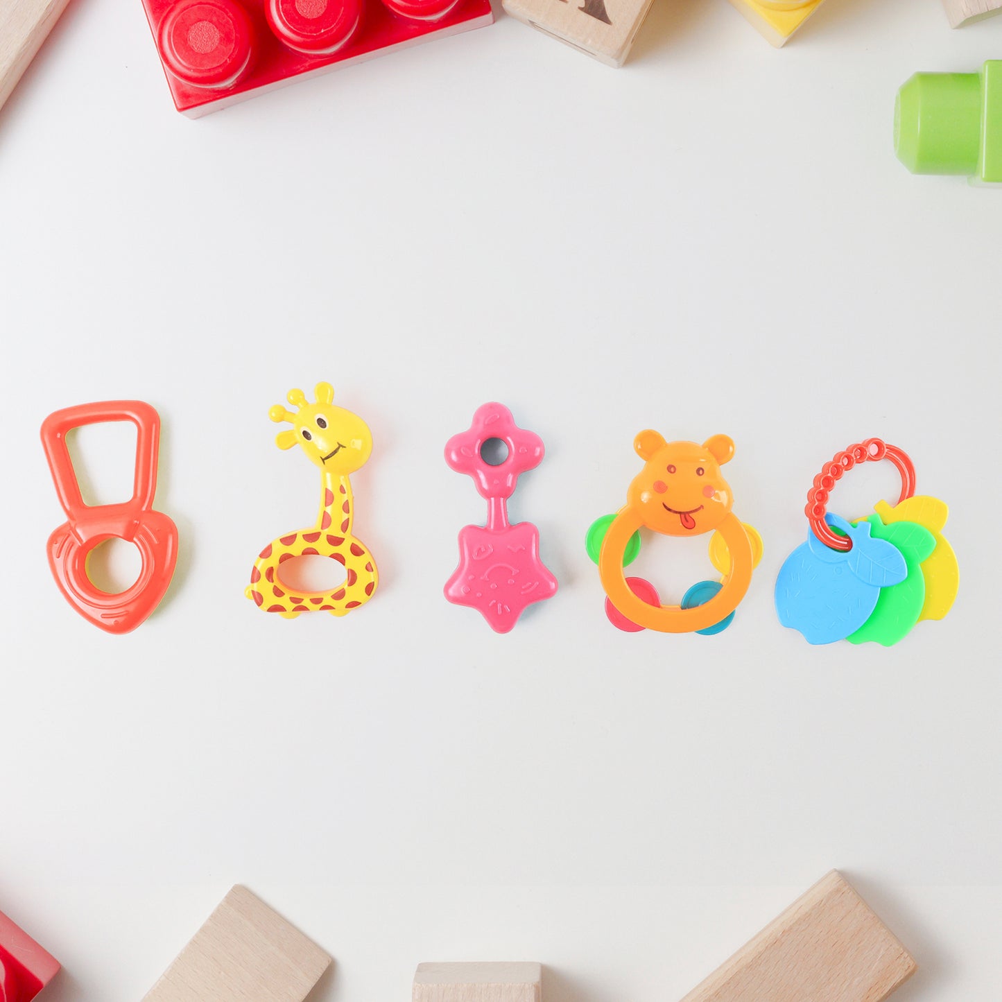 Set of five colorful Wukusy plastic baby rattle toys, designed for infants to shake and grasp for sensory play.