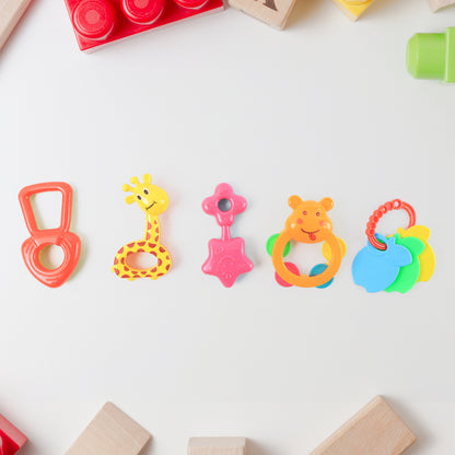 Set of five colorful Wukusy plastic baby rattle toys, designed for infants to shake and grasp for sensory play.