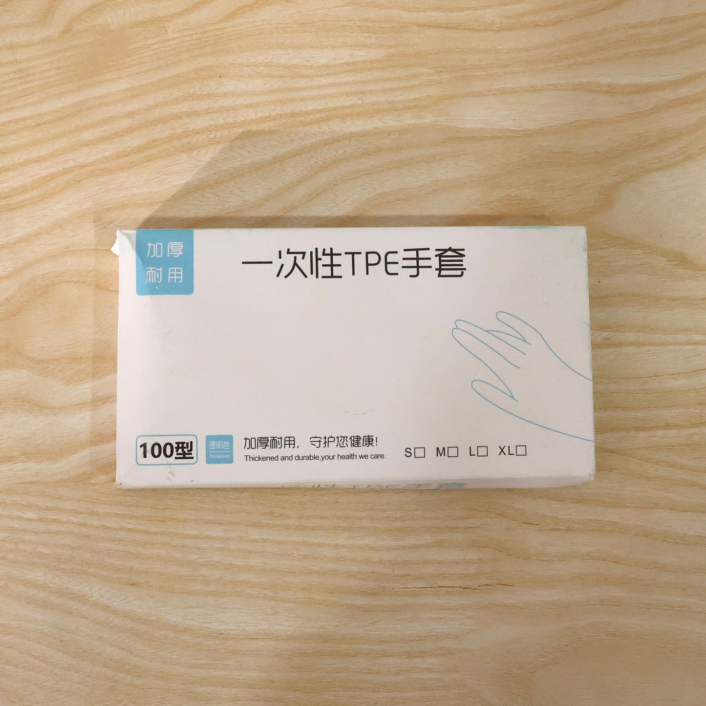 Box of 100 Wukusy disposable gloves for kitchen and household use, showing clear, white gloves ready for cleaning or food handling.