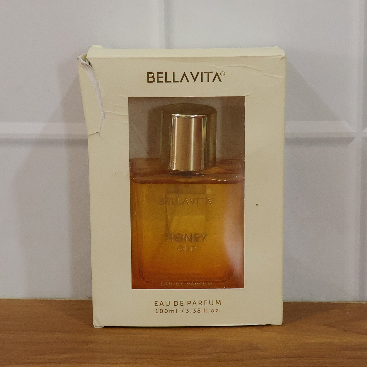 Bellavita Premium Honey Oud perfume bottle by Wukusy, featuring a sleek 100ml glass container with elegant gold accents.