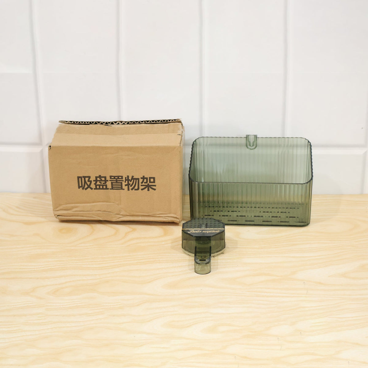 Transparent wall-mounted storage box by Wukusy for bathroom or kitchen, shown mounted on a wall for organized space.