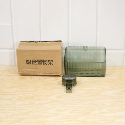 Transparent wall-mounted storage box by Wukusy for bathroom or kitchen, shown mounted on a wall for organized space.
