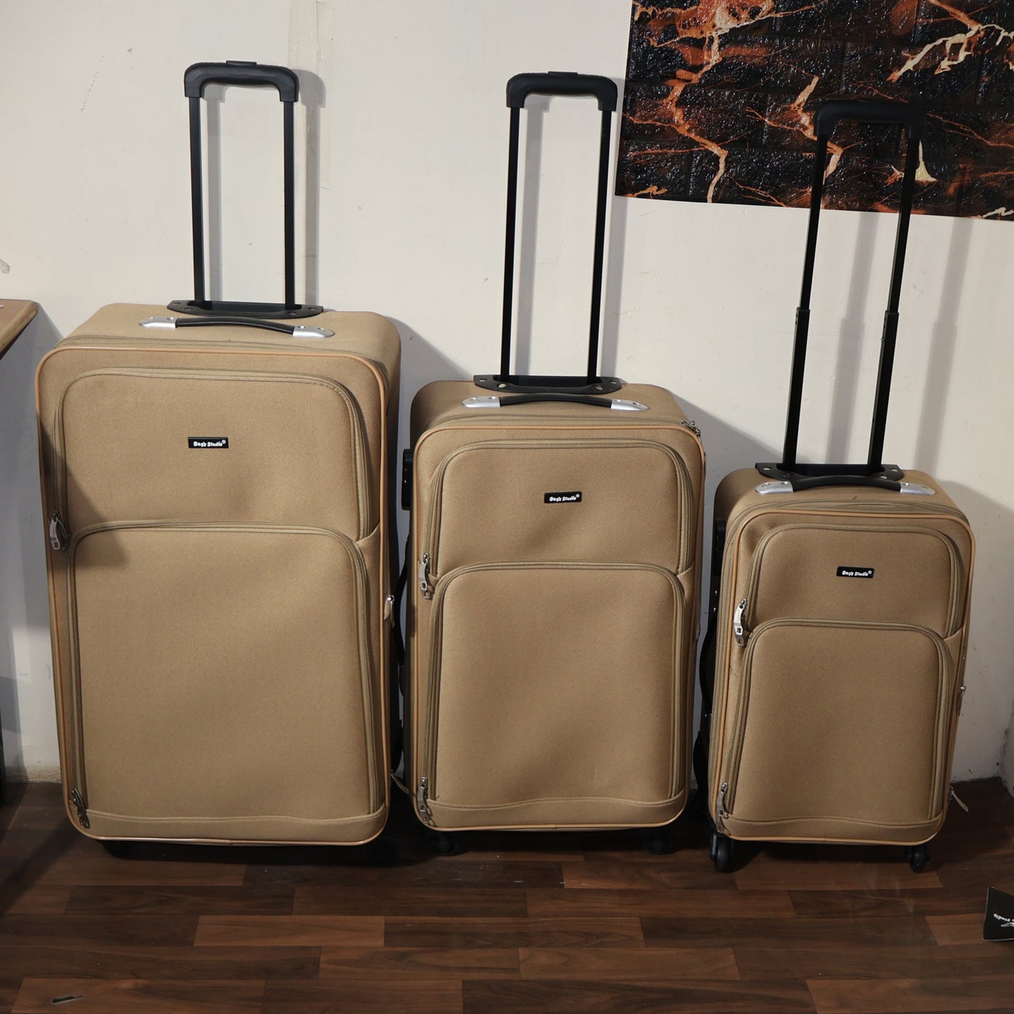 Wukusy 3-in-1 soft side trolley luggage set with three different-sized suitcases and wheels for easy travel.
