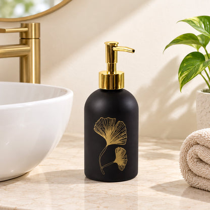 Wukusy manual liquid soap dispenser with leaf design and refillable pump bottle, shown with transparent container and green leaf accents.