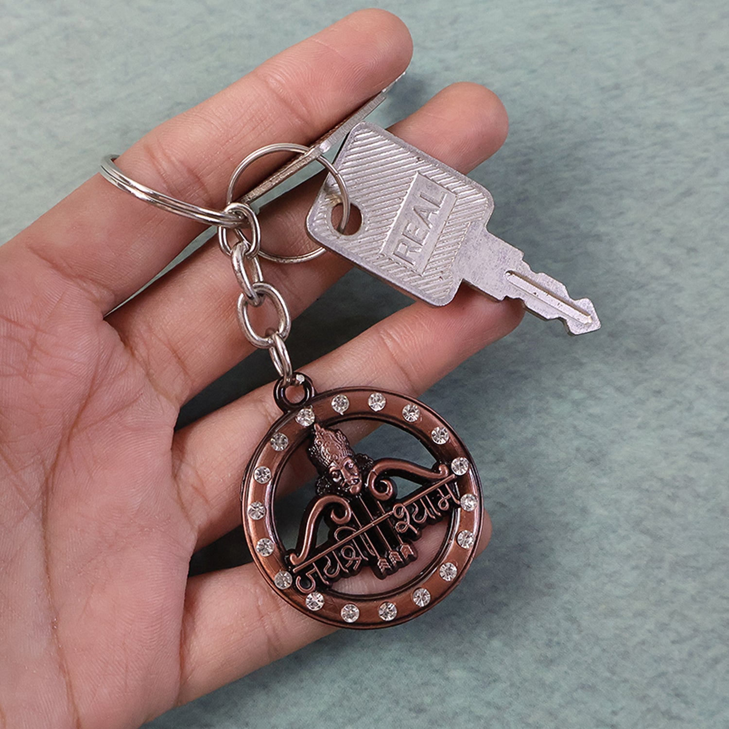 Decorative metal Jai Shree Shyam keychain by Wukusy featuring intricate design and detailed craftsmanship.