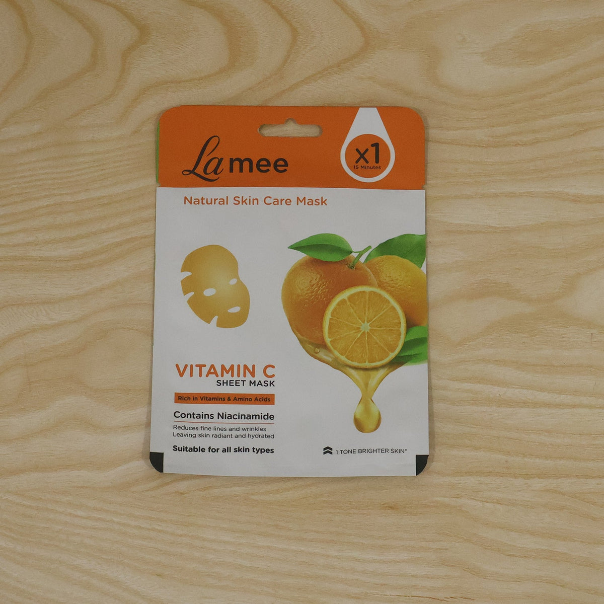 Wukusy Vitamin C facial sheet mask with niacinamide for hydrating skin care, showing the mask soaked in serum ready for use.