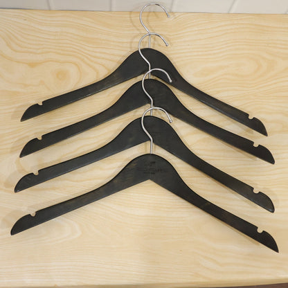 Set of four Wukusy premium clothes hangers with metal hooks for wardrobe storage, showcasing sleek and sturdy design.