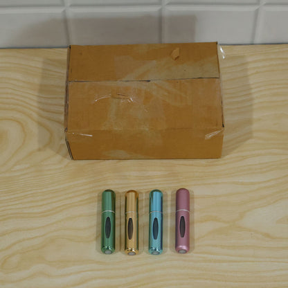 Set of four Wukusy mini refillable perfume spray bottles with refill valves, ideal for travel and on-the-go fragrance storage.