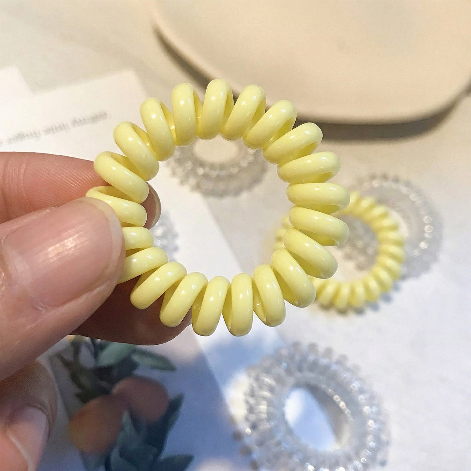 Colorful telephone wire hair band by Wukusy, featuring a mix of vibrant colors and flexible design for versatile styling.