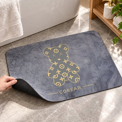 Grey bathroom mat with golden bear print, quick-drying absorbent fabric, 60x40 cm, by Wukusy, designed for bathroom comfort.