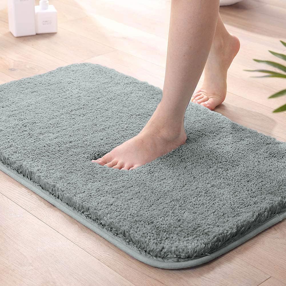 Silver Seasons bath mat for bathroom, soft and absorbent, shown on bathroom floor with textured surface and non-slip backing.