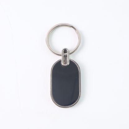 Elegant black and silver oval metal keychain by Wukusy, featuring a sleek design and durable metal construction.
