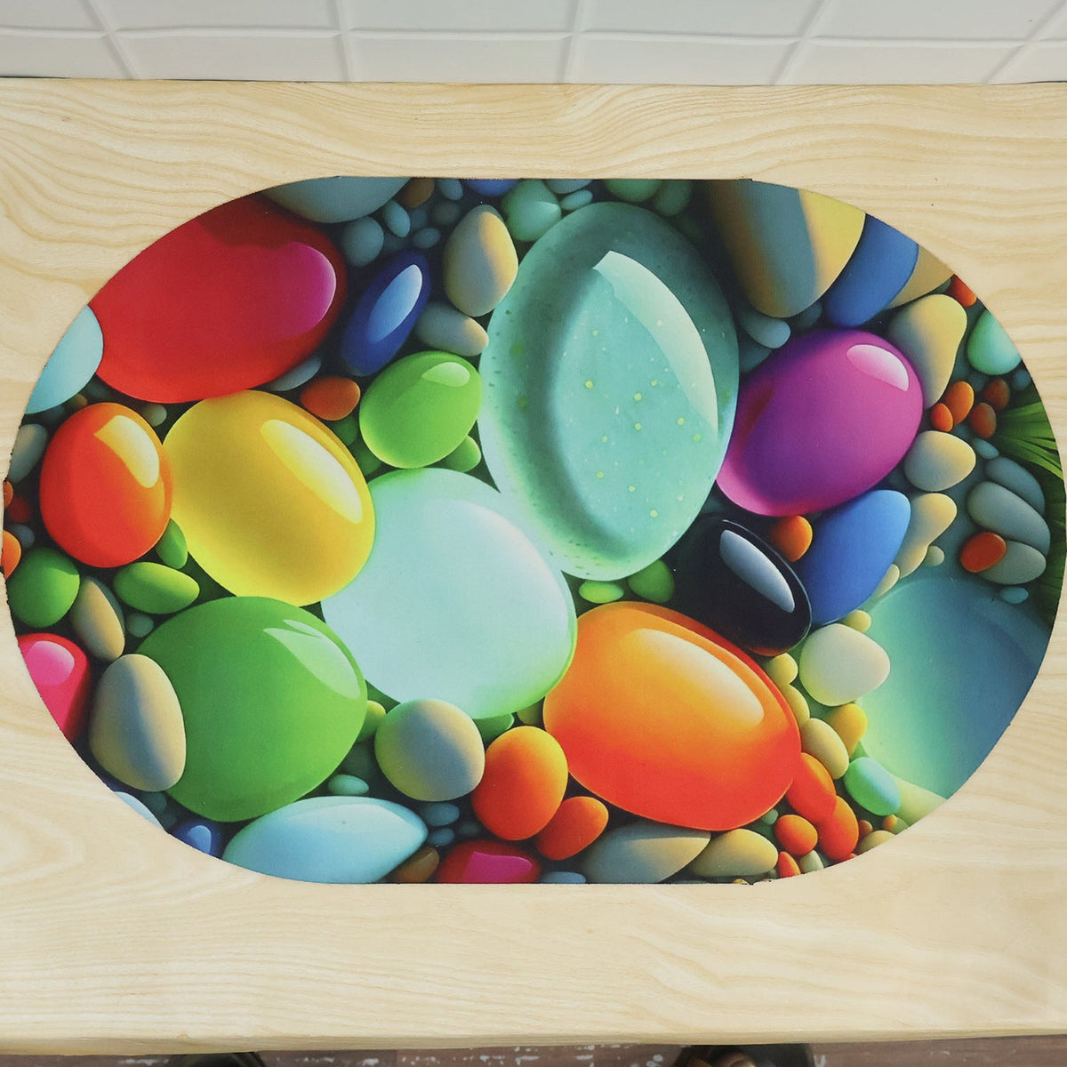 Colorful pebble print oval door mat by Wukusy, 57.5x38 cm, designed for home floor decor with vibrant pebble pattern.