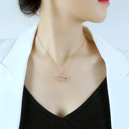Rose gold stainless steel chain pendant featuring a flying feather and heart with cubic zirconia, ideal for women's jewelry collection.