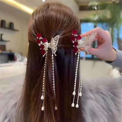 Luxury butterfly hair claw clip with rhinestones, velvet flowers, and dangling pearl tassels, elegant decorative hair accessory for women.