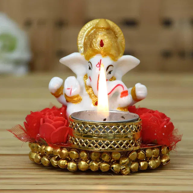 Decorative Lord Ganesha idol on a plate with tea light holder, intricate design, perfect for spiritual or festive decor.
