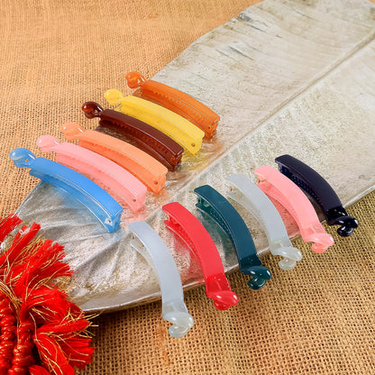 Set of 12 multicolor plastic banana-shaped hair clips by Wukusy, arranged in a colorful variety on a white background.