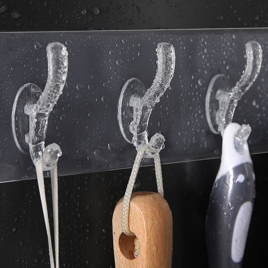Wukusy 4992 adhesive transparent heavy duty wall hook mounted on a wall for home organization and hanging items.