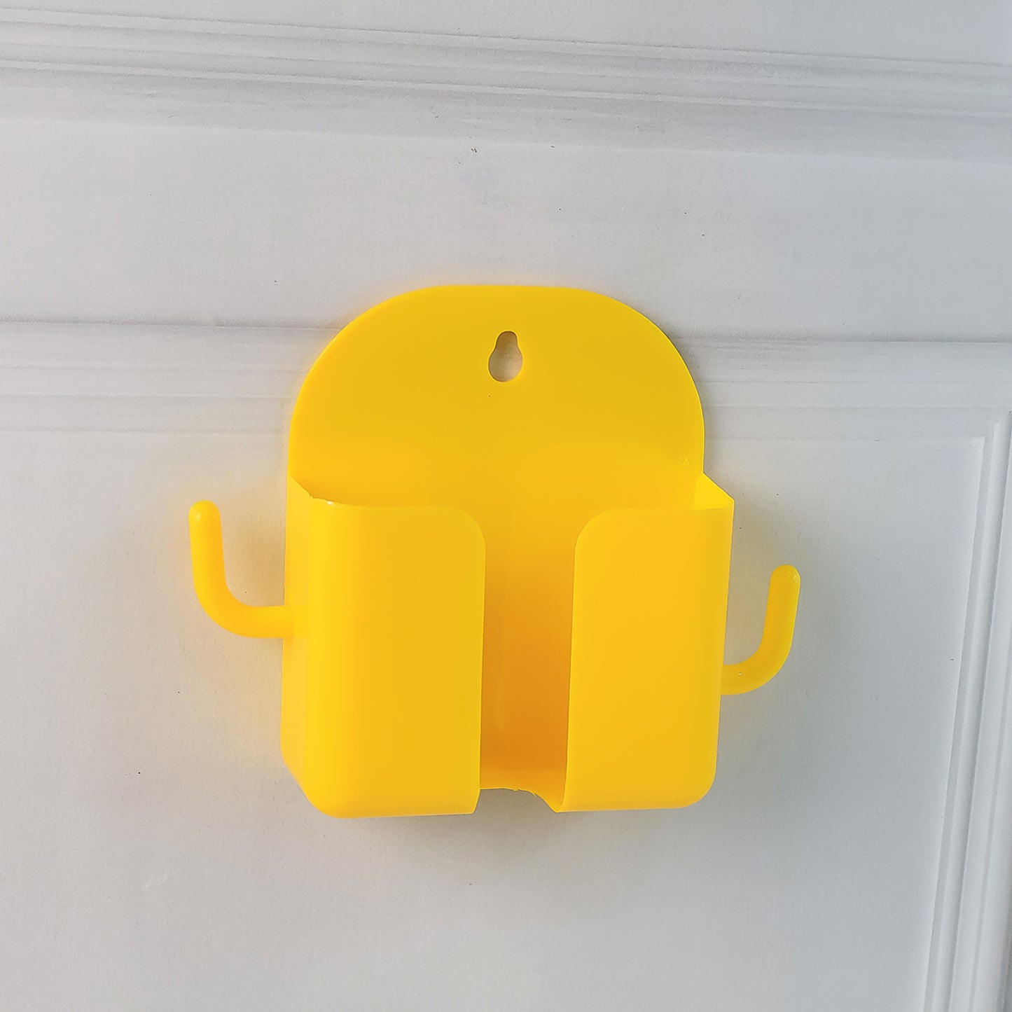 Orange wall-mount mobile stand by Wukusy with hook for holding mobile devices and accessories, mounted on a wall.