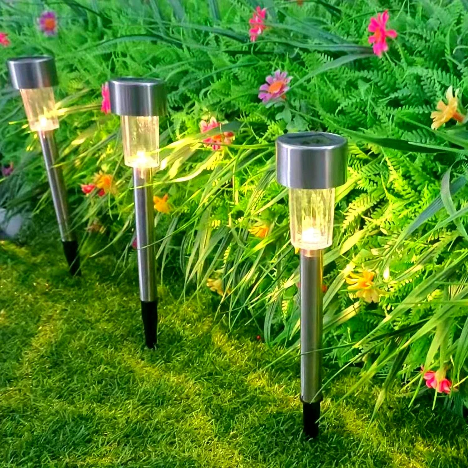 Set of 12 Wukusy solar garden lawn lamps illuminating outdoor yard and garden areas with modern design and automatic lighting.