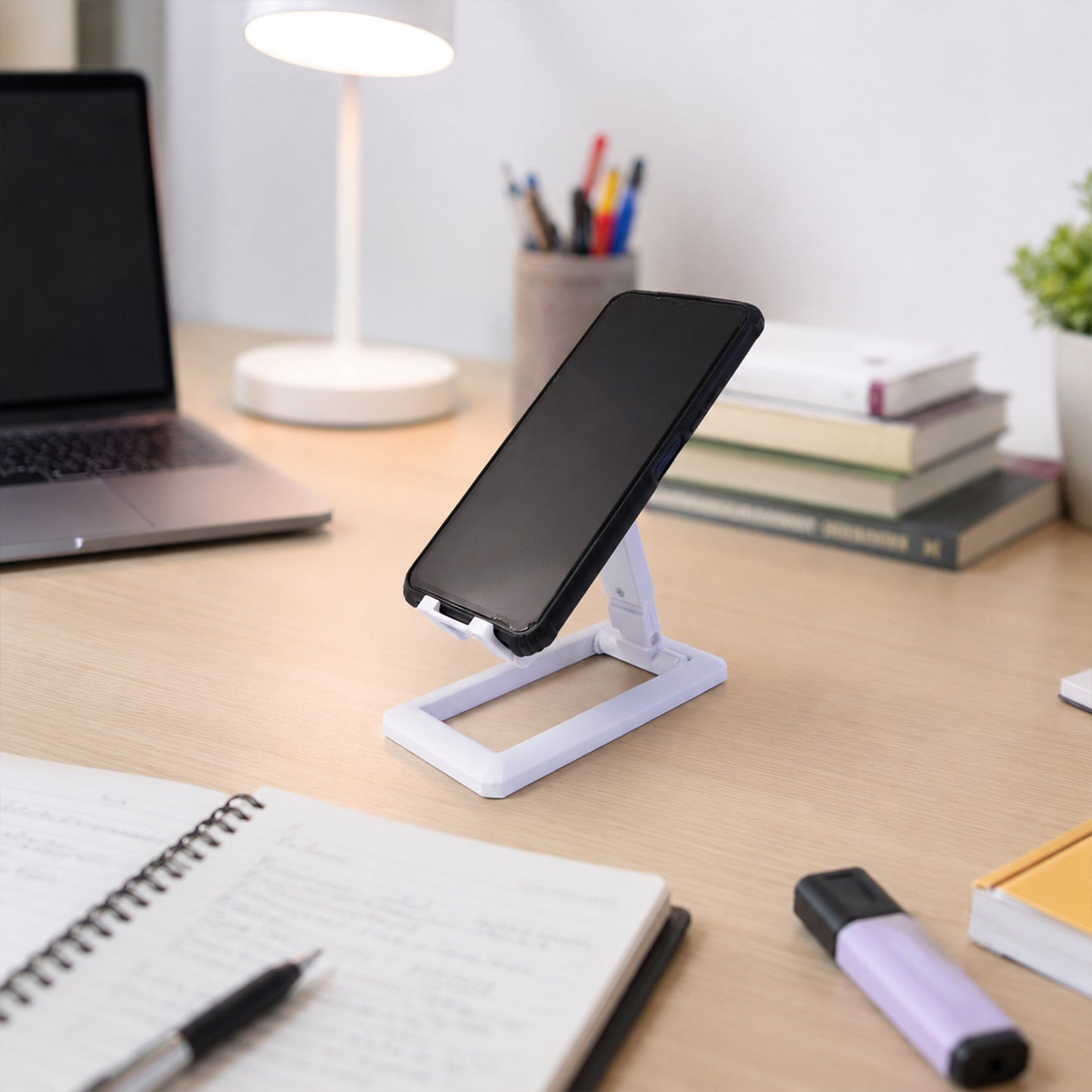 Wukusy foldable plastic mobile phone holder stand on a desk, adjustable and portable for office use.