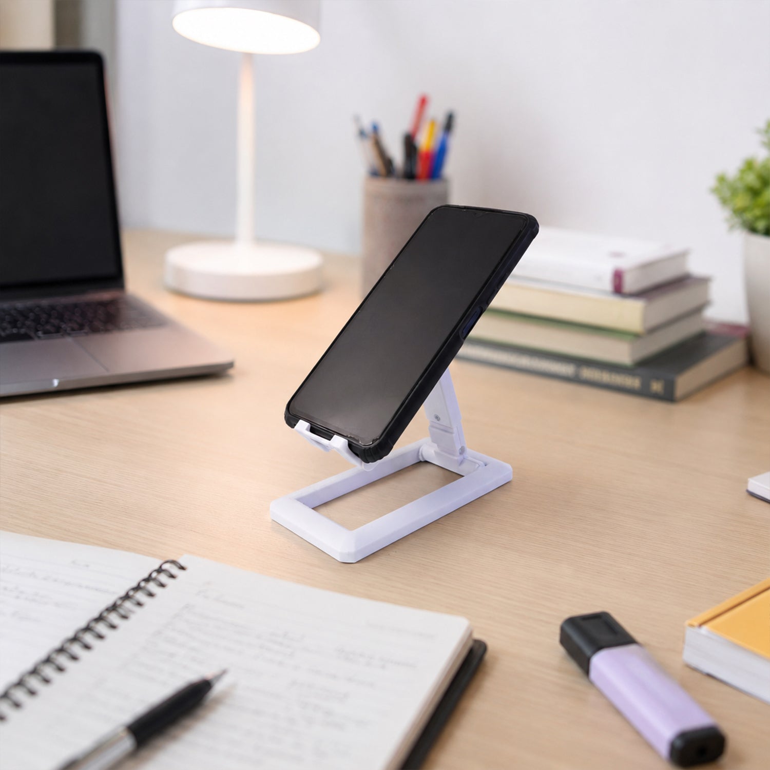 Wukusy foldable plastic mobile phone holder stand on a desk, adjustable and portable for office use.