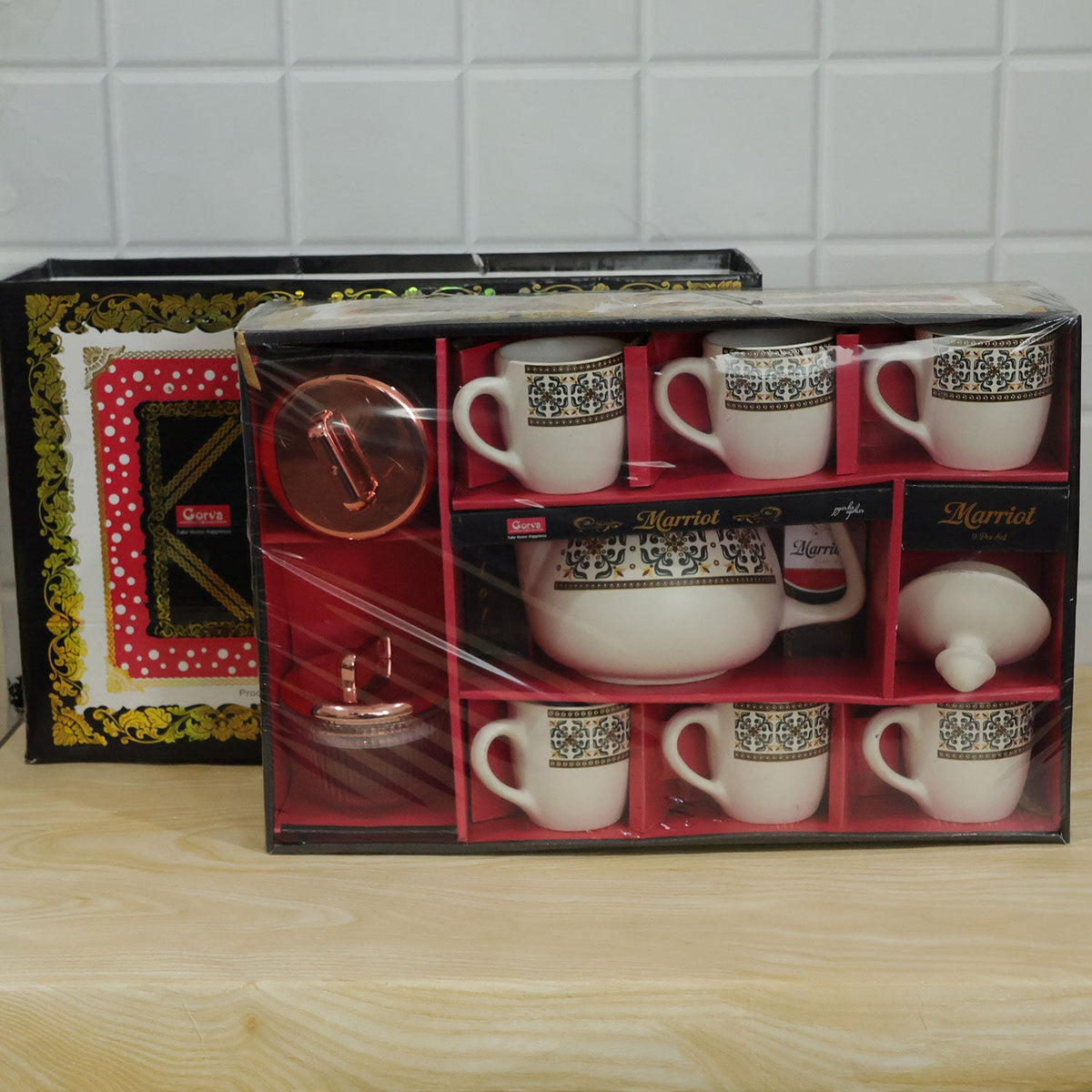 Wukusy tea gift set with kettle, 6 cups, and 2 dry fruit jars, 9-piece ceramic tea and dry fruit serving set on a wooden surface.