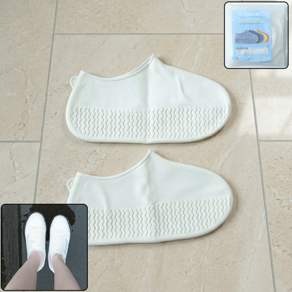 Pair of white waterproof silicone shoe covers by Wukusy, medium size, showing flexible, protective footwear for wet conditions.