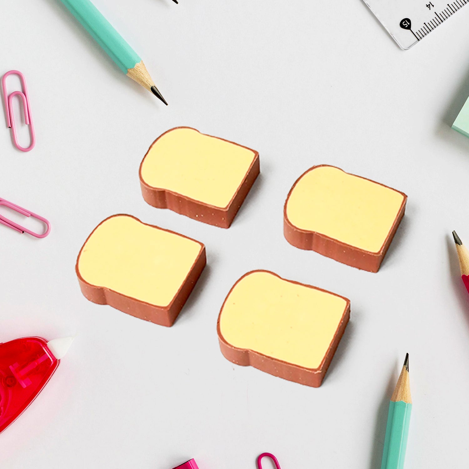 Set of four Wukusy bread-shaped 3D toast erasers for kids, featuring cute cartoon bread designs for school stationery and fun classroom use.