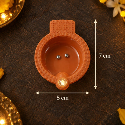 Set of 12 Wukusy flameless LED diyas water sensor lights for Diwali and pooja decorations, glowing softly in a festive setting.