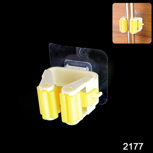 Wukusy Magic Sticker Series self-adhesive mop and broom holder mounted on wall, holding cleaning tools in a home improvement setting.