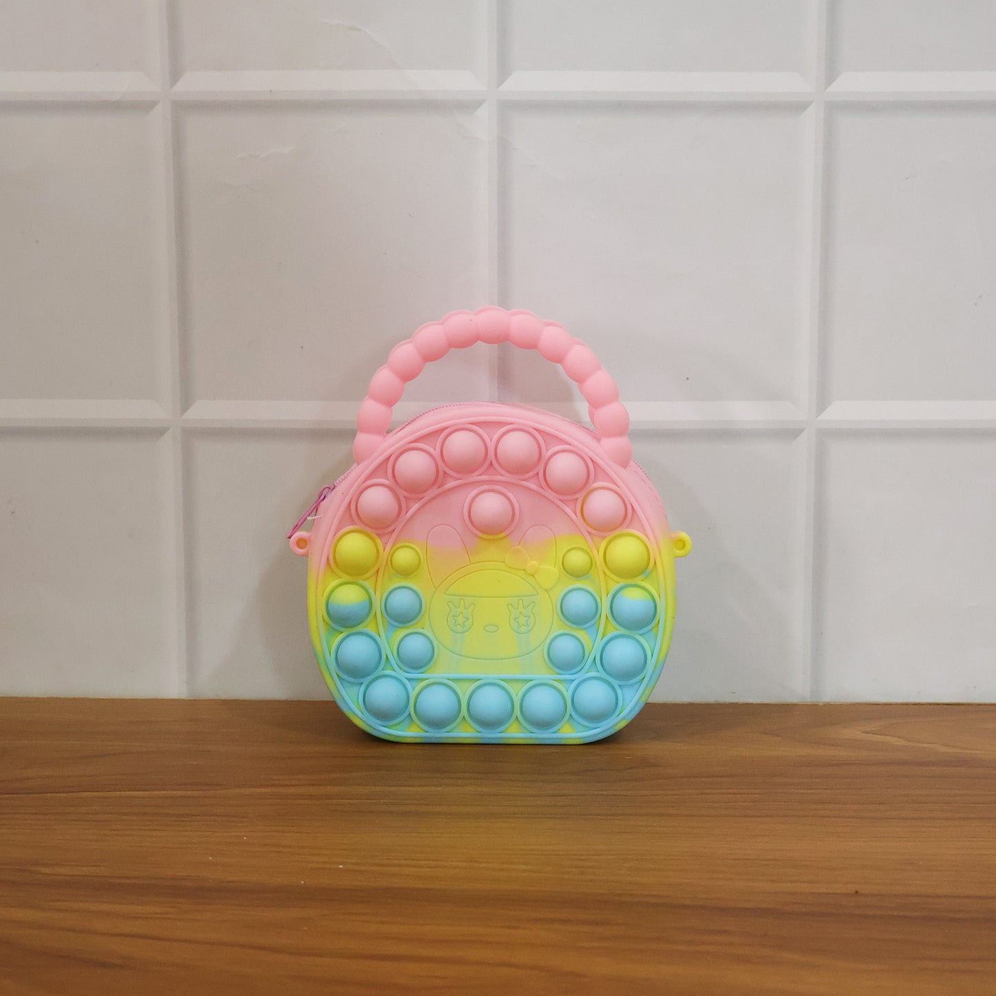 Rainbow round silicone Pop It coin purse by Wukusy with colorful, textured surface and compact size for easy carrying.