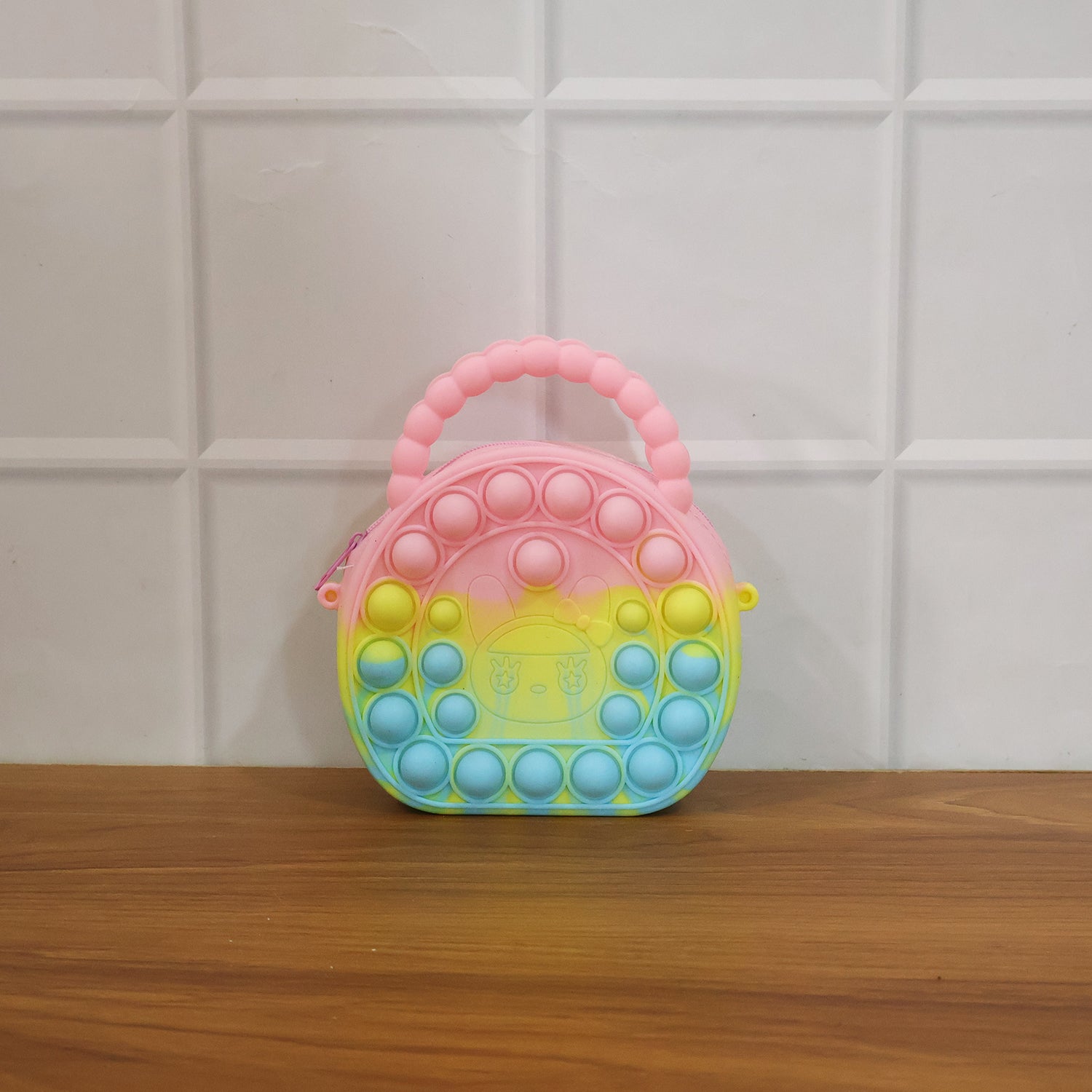 Rainbow round silicone Pop It coin purse by Wukusy with colorful, textured surface and compact size for easy carrying.