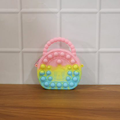Rainbow round silicone Pop It coin purse by Wukusy with colorful, textured surface and compact size for easy carrying.