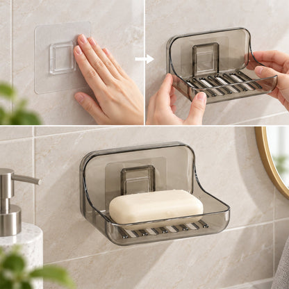 Wukusy Apex wall-mounted soap holder with drain and adhesive for bathroom, white plastic soap dish attached to tiled wall.
