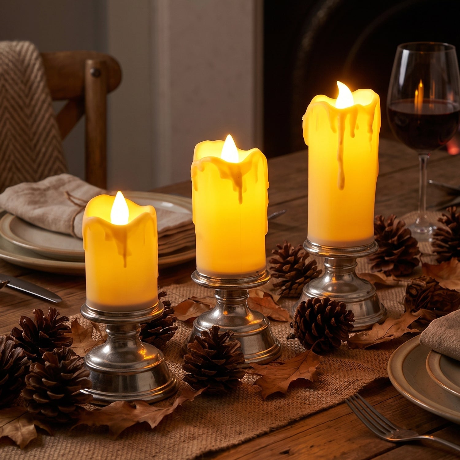 Set of three plastic flameless LED candles with pedestal stands by Wukusy, ideal for decorative display and ambient lighting.