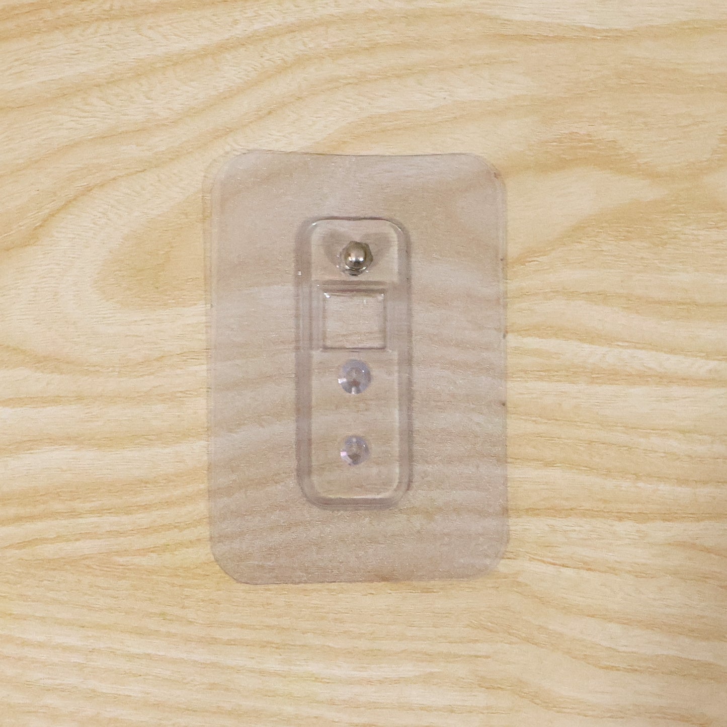 Wukusy adhesive plastic wall hook with strong hold, self-stick hanger for storage, shown attached to a wall in the image.
