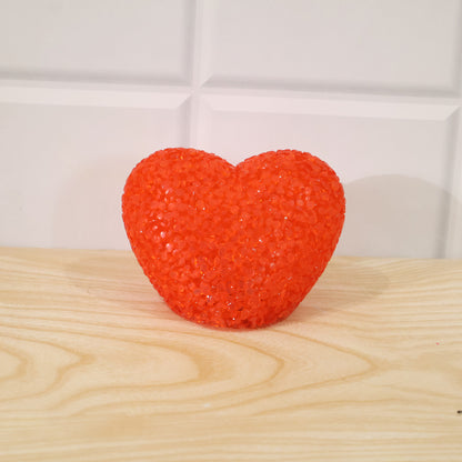 Heart-shaped LED night lamp with crystal texture emitting a soft red glow, perfect for cozy bedroom decor.